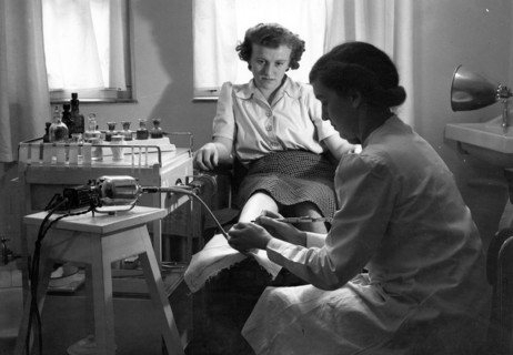 A Rowntree?s chiropodist works on a woman?s foot, York, Yorkshire, 1946. Artist: Unknown
