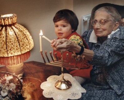 Girl lighting candles, Middlesex, London, 1989. Artist: Unknown