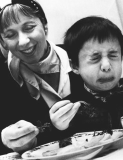 Child tasting bitter herbs at Passover, 1992. Artist: John Nathan