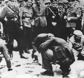 Jews are made to clean the streets of Vienna after the Anschluss, 1938. Artist: Unknown