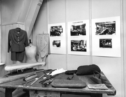 Reconstruction of a tailor's workshop in London's East End. Artist: Sidney Harris