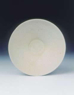 White ware bowl with moulded twin fish and floral pattern, Jin dynasty, China, 12th century. Artist: Unknown