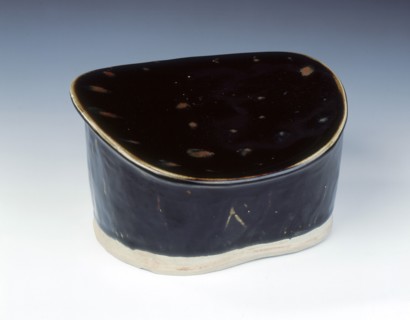 Ding black glazed pillow with hatched moulding, Jin dynasty, China, 12th century. Artist: Unknown