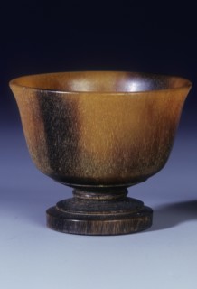 Plain circular rhino horn cup with turned stepped foot and stem, Qing dynasty, China, 18th century. Artist: Unknown