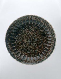 Brown Ding saucer with moulded floral decoration, Jin dynasty, China, late 12th-early 13th century. Artist: Unknown