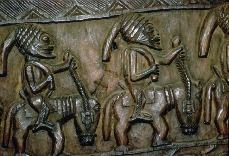 A carved wooden door from Nigeria depicting men on horseback. Artist: Unknown