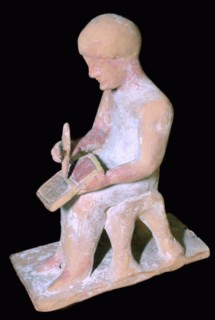 Greek terracotta of a man writing. Artist: Unknown