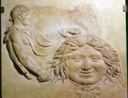 Roman fragment of a terracotta Campana relief showing head of Medusa with figure of Perseus. Artist: Unknown