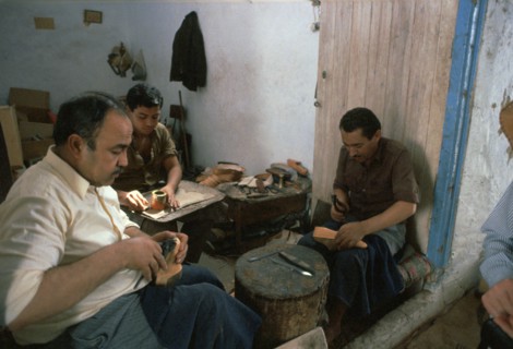 Shoemakers in a Tunisian souk. Artist: Unknown