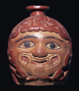 Greek terracotta scent bottle in the shape of a gorgon's head made in Rhodes. Artist: Unknown