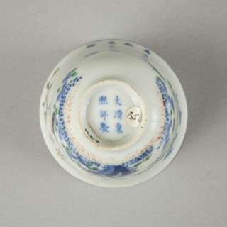 Underglaze blue month cup with polychrome enamelled decoration of a prunus tree. Artist: Unknown.