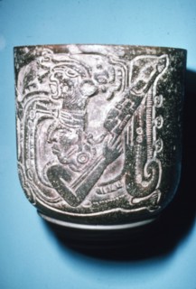 Mayan Pot of Man in high animal head-dress holding staff with lotus flower. Artist: Unknown.