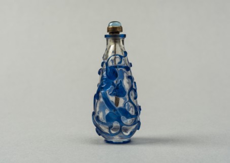 Clear glass snuff bottle with blue overlay, China, Qing dynasty, 1644-1911. Creator: Unknown.