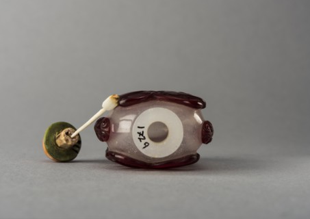 Clear glass snuff bottle with red overlay, China, Qing dynasty, 1644-1911. Creator: Unknown.