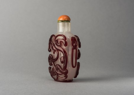 Clear glass snuff bottle with red overlay, China, Qing dynasty, 1644-1911. Creator: Unknown.