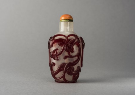 Clear glass snuff bottle with red overlay, China, Qing dynasty, 1644-1911. Creator: Unknown.