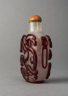Clear glass snuff bottle with red overlay, China, Qing dynasty, 1644-1911. Creator: Unknown.
