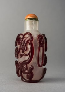Clear glass snuff bottle with red overlay, China, Qing dynasty, 1644-1911. Creator: Unknown.