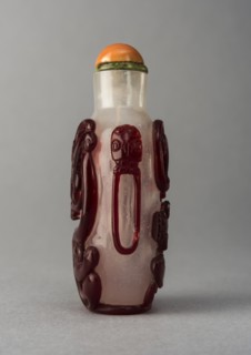 Clear glass snuff bottle with red overlay, China, Qing dynasty, 1644-1911. Creator: Unknown.