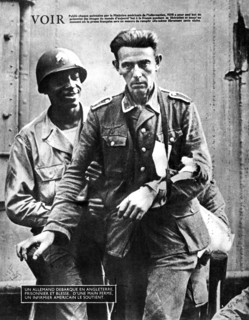 German prisoner of war arriving in England, escorted by an American soldier, 1944. Artist: Unknown