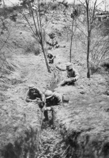 Fench sappers in gas masks re-laying telephone lines after a bombardment, 1918. Artist: Unknown