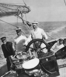 King George V at the helm of his yacht Britannia, c1930s. Artist: Unknown