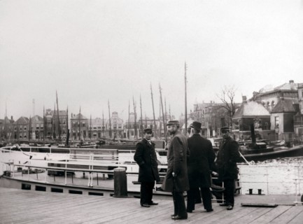 Men by a canal boat, Rotterdam, 1898.Artist: James Batkin