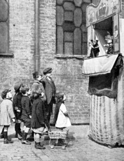 Children watching a Punch and Judy show in a London street, 1936. Artist: Donald McLeish