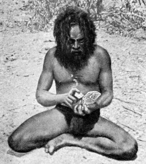 A man from the Warramunga tribe making a stone axe head, Australia, 1922.Artist: Spencer and Gillen