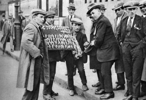 Street hawker selling football favours in King's Cross, London, 1911 (1926-1927). Artist: Unknown