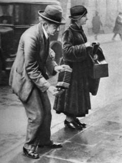 Kerb-side concertina-player, Holborn, London, 1926-1927. Artist: Unknown
