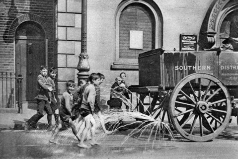 Boys following the Poplar Borough Council water cart, London, 1926-1927. Artist: Unknown