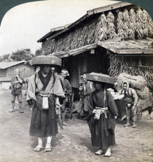 Pilgrim beggars beating little gongs, near Lake Kawaguchi, Japan, 1904. Artist: Underwood & Underwood