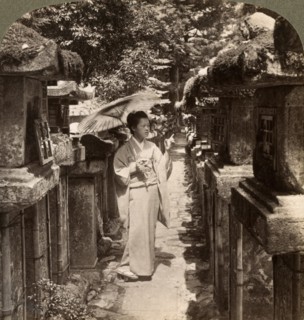 A woman Shinto devotee counting the stone lanterns, Kasuga Shrine, Nara, Japan, 1904.Artist: Underwood & Underwood