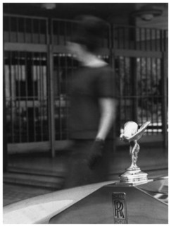 Woman walking past a Rolls-Royce. Artist: Unknown