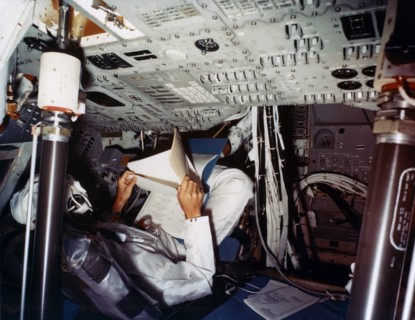 An astronaut inside a NASA Command Module, 1970s.Artist: NASA