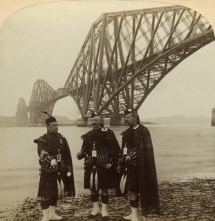 Men in Highland dress in front of the Forth Bridge, Scotland.Artist: Underwood & Underwood