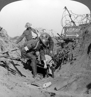 Carrying a wounded soldier to a first aid post, Passchendaele, Belgium, World War I, 1914-1918.Artist: Realistic Travels Publishers