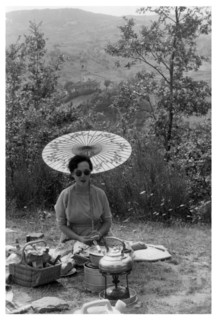Woman under a parasol having a picnic, c1950-1969(?). Artist: Unknown