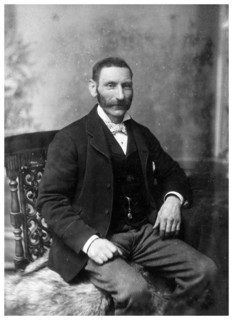 Man sitting in a chair, c1890-1909(?).Artist: Theodore Waltenberg