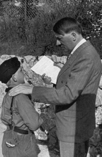 A young boy from the Hitler Youth shows Adolf Hitler a letter from his sick mother, 1936. Artist: Unknown