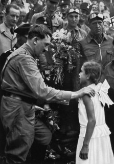Adolf Hitler talking with a young girl during his election campaign, 1932. Artist: Unknown