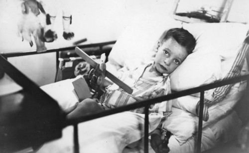 Greek boy from Pylos being nursed in the sick bay of the British battleship HMS 'Malaya', 1938. Artist: Unknown