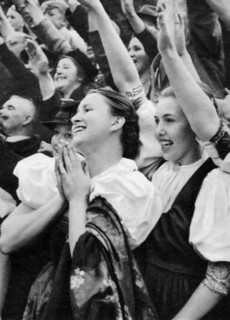 Admiring crowd saluting German Nazi leader Adolf Hitler, 1938. Artist: Unknown