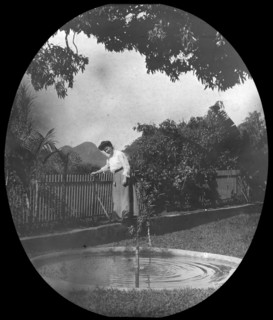 Woman by a pond in a garden, Rio de Janeiro, Brazil, late 19th or early 20th century. Artist: Unknown