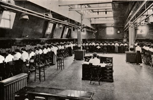 In a Large Telephone Exchange, c1916. Artist: Unknown.