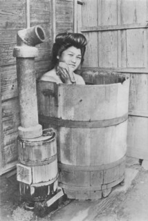 'The bath is a large barrel with charcoal stove. Frequently out of doors', c1900, (1921). Artist: Julian Leonard Street.