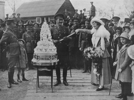 'A khaki wedding: Cutting the wedding cake with the bridegroom's sword', 1915. Artist: Unknown.