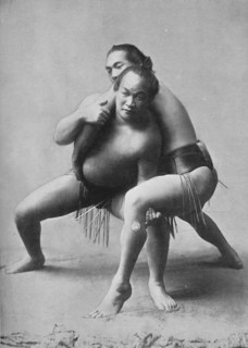 A sumo wrestling bout between a pair of Japanese professionals, 1902. Artist: Unknown.