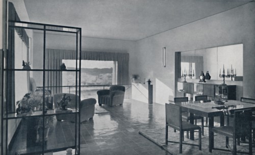 'Paniconi and Pediconi. A dining room with a large window and curtains designed to frame a beautiful Artist: Unknown.